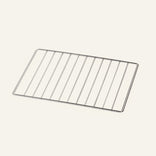 A rectangular metal cooling rack with parallel bars, photographed on a plain light background.