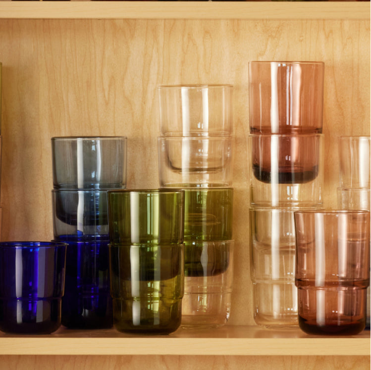 A collection of multicolor Tall and Short Night + Day Glasses in the cabinet