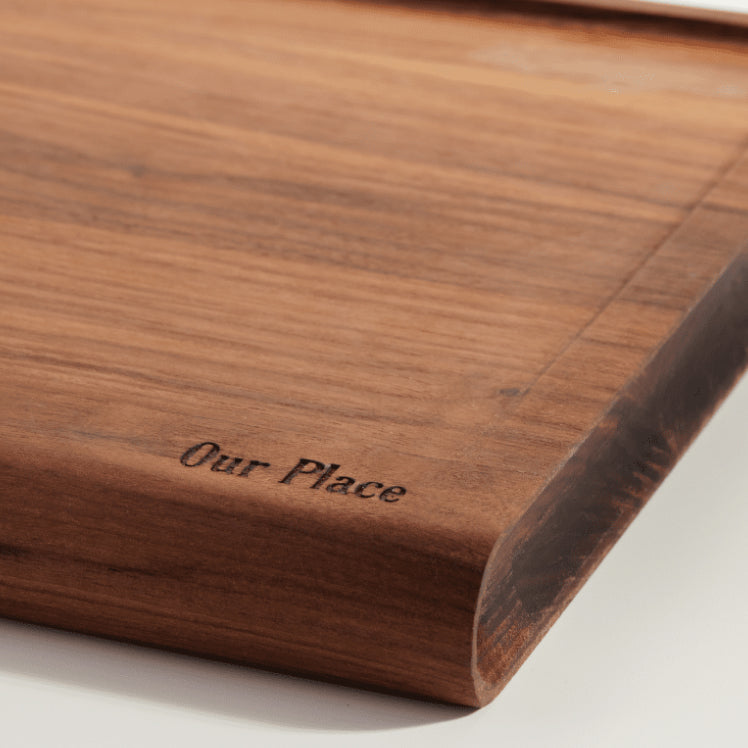 detail view of our place logo on walnut cutting board