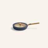 Blue frying pan with gold handle on a white background