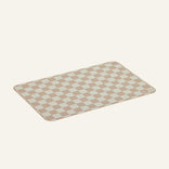 Checkered oven mat with beige and white squares on a light beige background