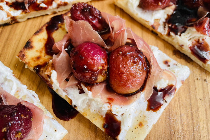 Naan Crostini with Roasted Grapes, Prosciutto, and Goat Cheese
