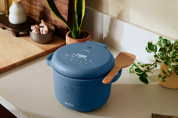 A blue Our Place rice cooker on a countertop