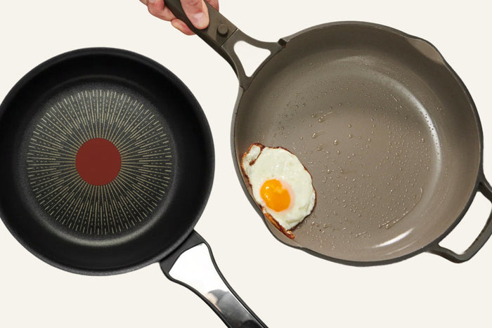 Two pans with an egg inside one of them 