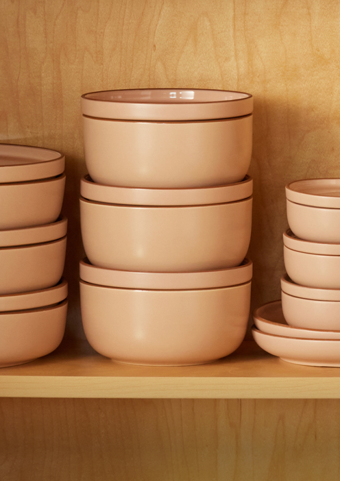 Pink tableware stacked on a shelf