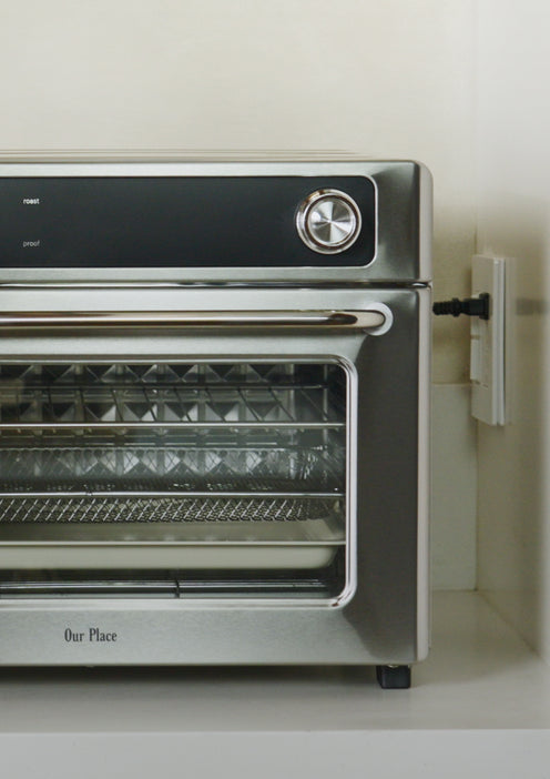 Stainless steel oven with glass door on a white countertop