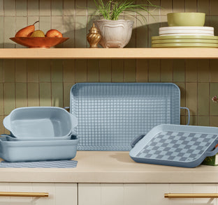 blue salt ultimate bakeware set on counter, includes bakeware set, griddle pan, oven rack, mini griddle pan, mini and regular oven mats