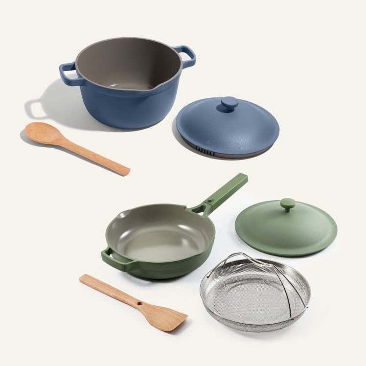 A blue Perfect Pot with spoon and a green Always Pan with spatula and steamer basket