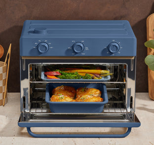 blue large wonder oven with vegetables and chicken on multi layer trays