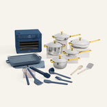 Collection of kitchen appliances and utensils including pots, pans, and a toaster oven on a white background.