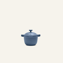 The Petite Perfect Pot, featuring a lid and two side handles, is showcased against a plain, light background.