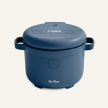 A blue electric rice cooker with a digital display and side handles, labeled Our Place, on a plain light background.