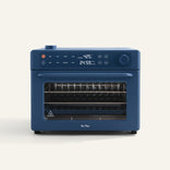 A blue countertop convection oven with digital display showing temperature and timer, control knobs on top, and a glass door revealing oven racks inside.