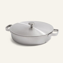A round Titanium Braiser Pro 28 cm, featuring two handles and a fitted lid, is shown on a plain light background.