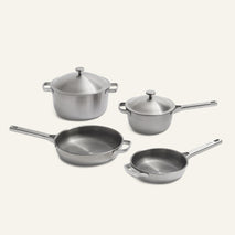 A four-piece Titanium Pro Cookware Set (2.0) of non-toxic stainless steel, including two saucepans with lids and two frying pans.