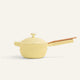 The Ceramic Nonstick Perfect Pot 2.5 L, featuring a yellow finish, a matching lid, and a light brown handle, is displayed against a plain light background.