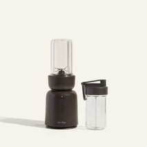 Black portable blender with clear container on a white background