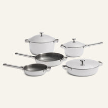 Elevate your kitchen with the Titanium Pro Cookware Set + Braiser, featuring five premium stainless steel pieces: two saucepans with lids, a pot with lid, a sauté pan, and a frying pan—all artfully showcased on a crisp white background.
