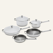 Titanium Pro Cookware Set+ (2.0) featuring two pots with lids, two deep frying pans, and one shallow frying pan with a lid, all made of stainless steel.