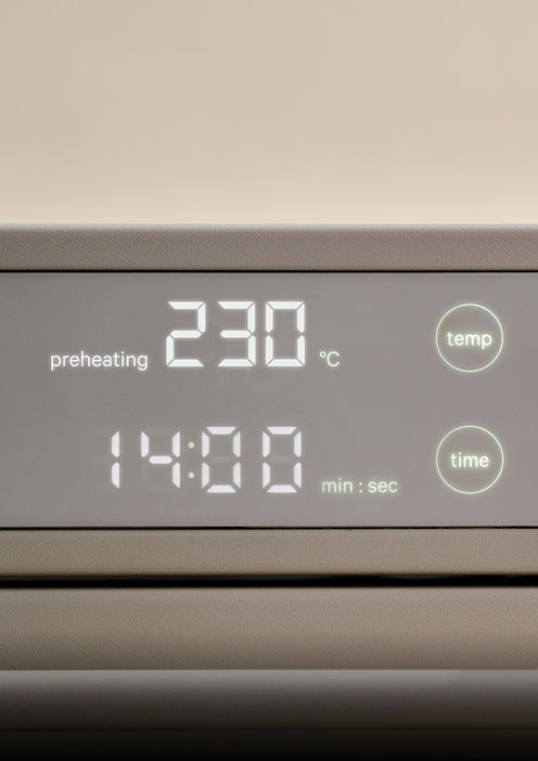 Digital oven display showing a preheating temperature of 230 degrees Celsius and a timer set to 14 minutes.