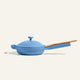 The Ceramic Nonstick Always Pan 20 cm, featuring a blue finish, nonstick surface, lid, and wooden handle, is displayed against a plain, light background. This versatile pan delivers convenience and multifunctionality for any kitchen.