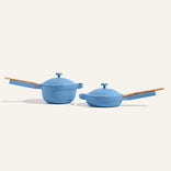Two blue cookware items on a beige background