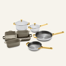 Titanium Pro Cookware + Bakeware Set (2.0) featuring stainless steel cookware and ceramic bakeware with gold-toned handles and lids.