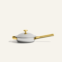 A non-toxic Titanium Always Pan Pro 20 cm (2.0) frying pan with a matching lid, featuring a gold-toned handle, lid knob, and side helper handle.