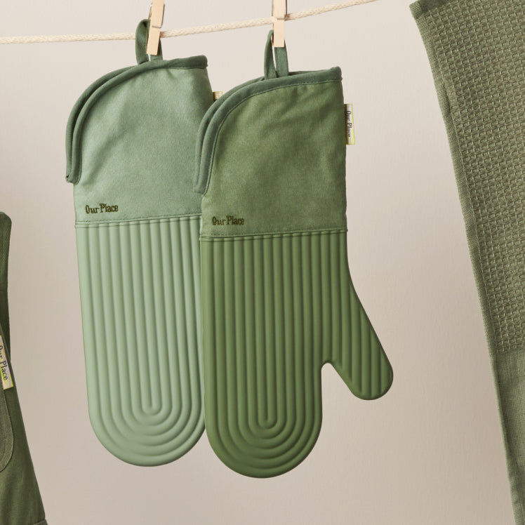 Green Hot Mitts hanging on a clothesline