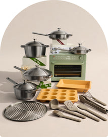 Collection of kitchen utensils and appliances including pots, pans, an oven, and baking trays on a neutral background.