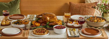 Thanksgiving tablescape set with our place assortment includes, dinner plates, salad plates, party coupes, always pan, walnut cutting board