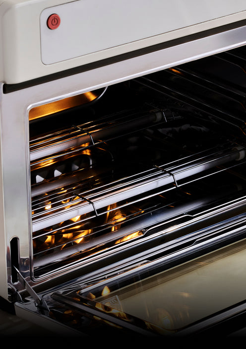 Close-up of a modern oven with open door showing interior racks.