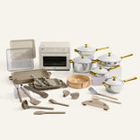 Collection of kitchenware including pots, pans, and utensils on a white background