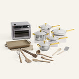 Set of cookware and kitchen tools including pots, pans, and utensils on a white background