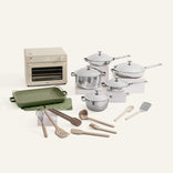 Kitchen appliance set including pots, pans, and utensils on a white background
