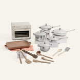 Collection of kitchen appliances and utensils including pots, pans, and a toaster oven on a white background.