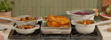 beige always pan, mini always pan, griddle pan, oven rack, perfect pot and mini perfect pot on stove with holiday dinner