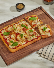 Pizza Margherita on walnut cutting board