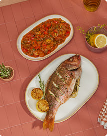 Whole Roasted Fish with Smoked Cherry Tomato Salsa on white serving platter