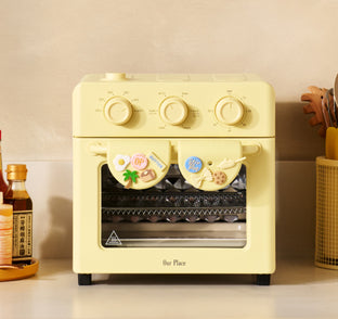 Yellow toaster oven on a kitchen counter with decorative elements.