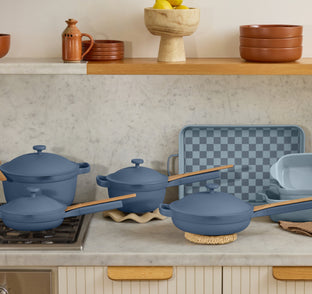 blue ultimate cookware set on stove and counter