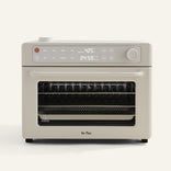 beige oven with digital display on white background