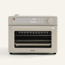 beige oven with digital display on white background