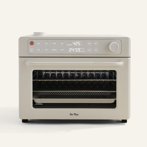 beige oven with digital display on white background