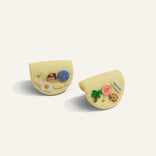 Two yellow silicone hot grips \ with crocs gibits on a white background