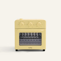 yellow toaster oven on white background