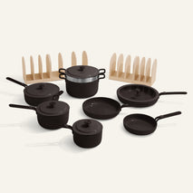 Set of black cookware including pots and pans on a white background