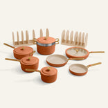 Set of ceramic cookware with lids on a light background