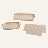 Set of two beige trays with gold handles and a matching checkered mat on a white background