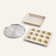 Set of three baking trays including a square pan, a muffin tray, and a pizza pan on a white background.